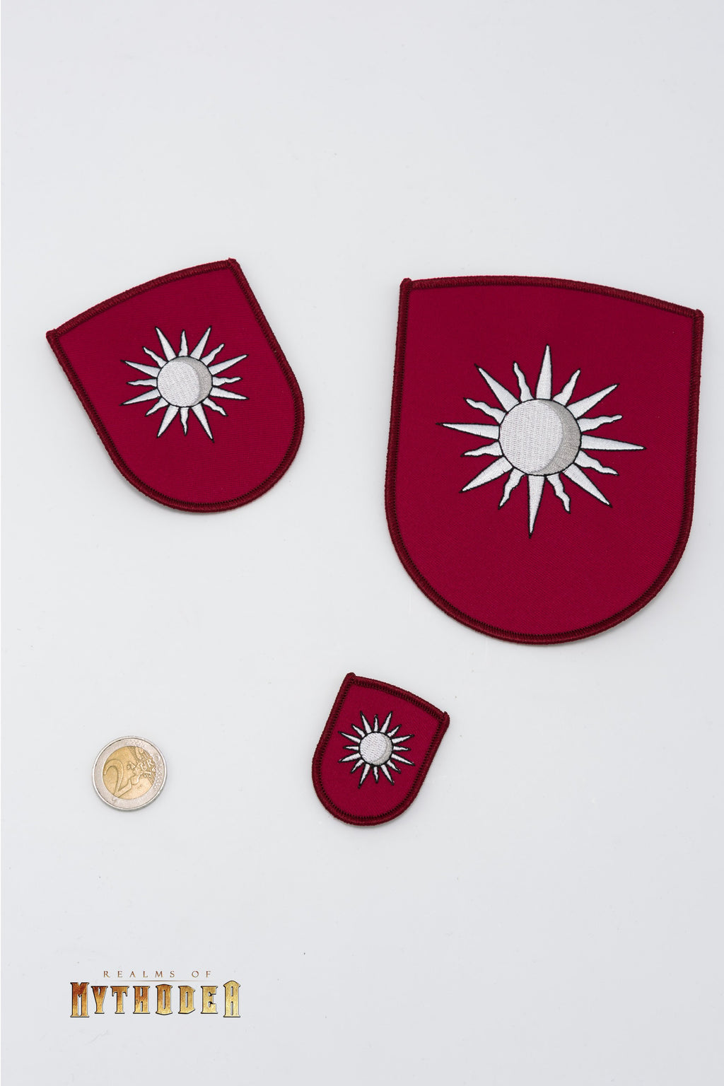 Mythodea Iron On Patch Atteron would be translated to French as \"Écusson Thermocollant Mythodea Atteron\".