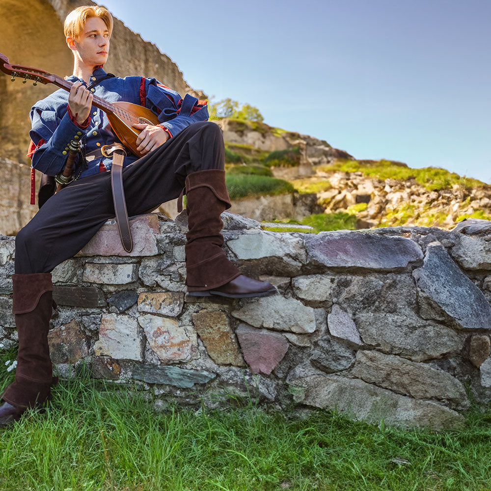 D&D bard dressed in blue and red garments, playing his lute on side of the road. 